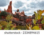 Small photo of PARIS, FR - Jul 01, 2022: The Big Thunder Mountain Railroad Attraction by a river in Disneyland