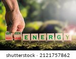 Small photo of Nuclear or green energy symbol, The businessman turns over the cubes, and the concept of dangerous nuclear energy changes to a safe green one. European green taxonomy, the concept of green energy