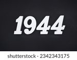 Black for the background. The number 1944 is made of white painted wood.