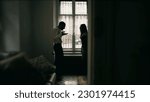 Small photo of Silhouette of couple fighting each other, arguing and yelling at one another. Young man and woman shouting in anger. Candid behind closed doors