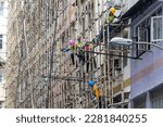 Small photo of 2023 Mar 29,Hong Kong.Workers dismantle the bamboo scaffolding outside the building