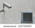 Small photo of Security camera on the wall next to a ventage