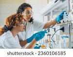 Small photo of In a chemistry lab, two diligent workers conduct experiments, kindling their passion for science and discovery.