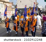 Small photo of Ambala, India- December 08 2021: 'Panj-Pyaare' (Five Khalsa children) dressed up in traditional attire holding flags during Sikh procession in the streets of a town in Haryana,India.