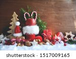 Stuffed red Santa Claus boot with apple and candy cane.Christmas background