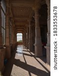 Small photo of Katariyasar, Bikaner, Rajasthan / India - October 02,2020: Red stone artistic large pillars in the sanctum sanctorum of the huge temple of Sant Jasnathji built in Katariyasar