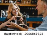 Bonding relationship. Interested excited falling in love mature woman listening to her husband man boyfriend while drinking coffee in restaurant cafe on a date