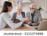 Successful deal. Lawyer financial adviser helping consulting showing contract mortgage loan credit business startup, signing documents by elderly senior old grandparents couple at home