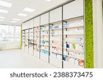 Small photo of Empty pharmacy chemist`s store drugstore with white shelves full of medicines, jars with drugs, pills, remedy, antibiotics, vitamins. Copy space