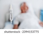 Small photo of Close up shot of medicine in and iv drip and patient on background in hospital room. Focused photo of saline dropper. Hospitalization and reanimation