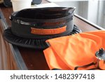 Small photo of Ticket Collector hat and high vis jacket on a bench