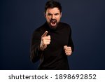 Small photo of Man threatening person with angry outraged expression, lose temper standing distressed, pointing camera accuse someone, blame girlfriend, having argument and shouting, Blue background.
