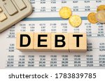 Small photo of Wooden blocks with the word Debt. Reduction or restructuring of debt. Refusal to pay debts or loans and invalidate them