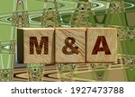 Small photo of Wooden cubes with the abbreviation M and A on them. Business merges and aquisitions concept.