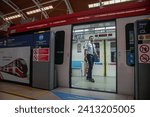 Small photo of JAKARTA, INDONESIA-JANUARY 2024- Train officers inspect carriages in the Jabodebek LRT train series at Dukuh Atas LRT station on 16, January 2024 in Jakarta.