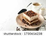 Composition with plate of tasty tiramisu on white background. Delicious dessert