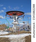 Small photo of Cableway station. Moving chairs arriving at the end station are unhooked from the traction rope and moved through it using guide wheels. Elbrus region, mountain landscape in the Caucasus.
