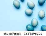 Easter frame of eggs painted in blue color. Flat lay, top view. Copy space for text.