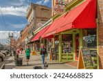 Small photo of Ogden, UT, US-January 29, 2016: Colorful downtown of this Utah city with quaint brick buildings and scenic snow-capped mountains in background.