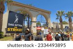 Small photo of Los Angeles - July 19, 2023: Striking SAG AFTRA and WGA members walk a picket line in front of Paramount Pictures in Hollywood