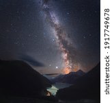 Small photo of Photograph of the night sky. Milky Way over a mountain lake. There are many small stars throughout the image field. Soft focus. natural background.