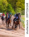 Small photo of GRONINGEN NETHERLANDS - MAY 13, 2021: Riders compete during their harness racing or horse sulky race at the "Royal Drafbaan Groningen"