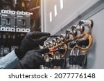 Small photo of Electricity and electrical maintenance service, Close-up circuit breaker has engineer using measuring equipment checking electric volt at terminal block and cable wiring main power distribution board.