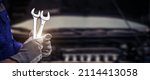 Small photo of Car care maintenance and servicing, Close-up hand technician auto mechanic using the wrench to repairing change spare part car engine problem and car insurance service support.