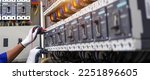 Small photo of Electricity or electrical maintenance service, Electrician hand checking electric current voltage at circuit breaker terminal and cable wiring check in main power load center distribution board.