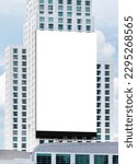 Small photo of Mock up white large LED display vertical billboard on tower building .clipping path for mockup