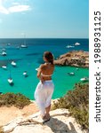 Small photo of Mediterranean Sea beach at Ibiza island, stunning seaside scenery of Cala Tarida, With young girl looking at the views