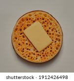 Small photo of Crumpet with a square of butter on top.