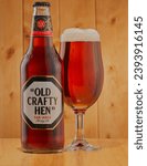 Small photo of Mansfield,Nottingham,United Kingdom,24th November 2023:Studio product image of Old Crafty Hen ale in a bottle and glass,Brewed by Morland Brewing.