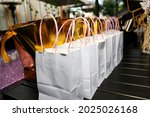 Small photo of A view of several goodie bags on a table, seen at a reception event.