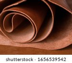 Small photo of Genuine Leather. Sewing a purse. Leather work. Tools for sewing bags, wallets, clutches. Stitching. Manual sewing of the product. The manufacture of leather products.