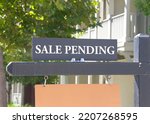 Small photo of Close up on Sale Pending sign in front of a California Home. Housing crisis, homes for sale.
