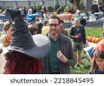 Small photo of San Francisco, CA - Oct 22, 2022: Senator Scott Wiener with participants at his Halloween Pumpkin Carving Event at Noe Courts park.
