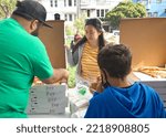 Small photo of San Francisco, CA - Oct 22, 2022: Senator Scott Wiener's staff serving pizza at his Halloween Pumpkin Carving Event at Noe Courts park.