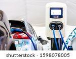 A modern electrical fast charger for the electrical or hybrid PHEV automobiles. An Energy power of future. Ecology friendly charger concept. Home electric car battery charger.