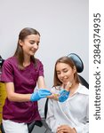 Small photo of A hygienist guides the woman through the steps, emphasizing the importance of thorough brushing and flossing to maintain oral health.