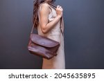 Woman Carries Brown Leather...