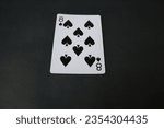 Small photo of ogan ilir,Indonesia-july 22th,2023:eight of spade. rummy isolate on black background. selective Focus image