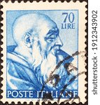 Small photo of Rome, circa 1961: Italian used postage stamp from Michelangelo Buonarroti's commemorative series, depicting the head of the prophet Zacharias in the vault of the Sistine chapel.