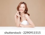 Small photo of Young Asian beauty woman curly long hair with korean makeup style on face and perfect skin showing Love sign on isolated beige background. Facial treatment, Cosmetology, plastic surgery.