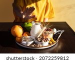 Small photo of Elimination diet concept. A woman avoids food allergens - fish, seafood, dairy, peanuts, tree nuts, eggs, chocolate, wheat, soy, citrus fruits. Avoidance phase.