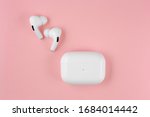 Air Pods pro. with Wireless Charging Case. New Airpods pro on pink background. Airpodspro. female headphones. 