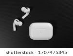 Air Pods Pro. with Wireless Charging Case. New Airpods pro on black background. Airpods Pro. Copy space. white wireless headphones on black surround background