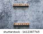 Small photo of Wood cube letter word of Disunion and Teamwork. Idea of motivation or inspiration in business vision and corporate management strategy. Leadership lead team to reach goal or achievement.