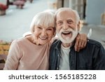 Elderly couple. Joyful nice elderly couple smiling while being in a great mood