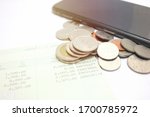 coins and phone on account book ... | Shutterstock . vector #1700785972